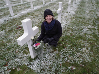 Woman by Cross Headstone in cemetary