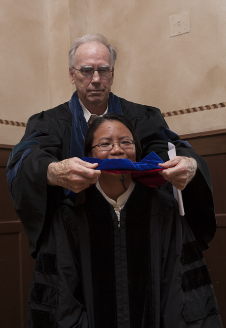 Michael Cullinane hooding Maureen Justiniano