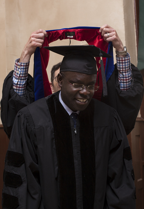 Neil Kodesh hooding Patrick Otim