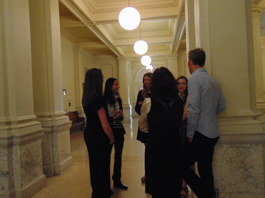Graduating students talking with Professor Kathryn Ciancia
