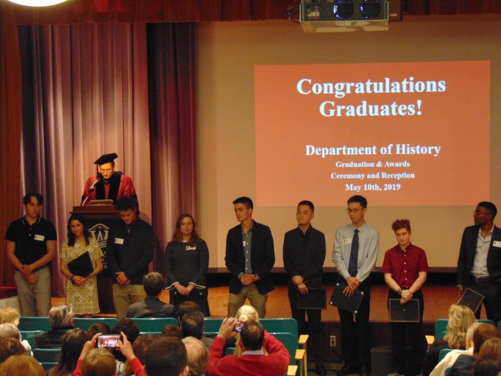 History majors receiving History Department awards line up as Professor Patrick Iber announces their names