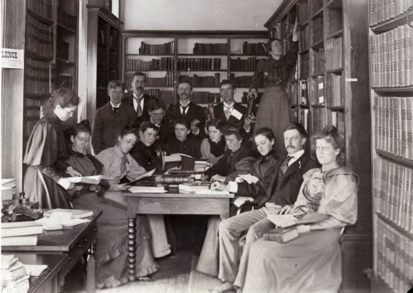 This image shows historian Frederick Jackson Turner and his seminar ca. 1893-1894. Professor Turner is seated second from the right, and the two women standing were staff members.