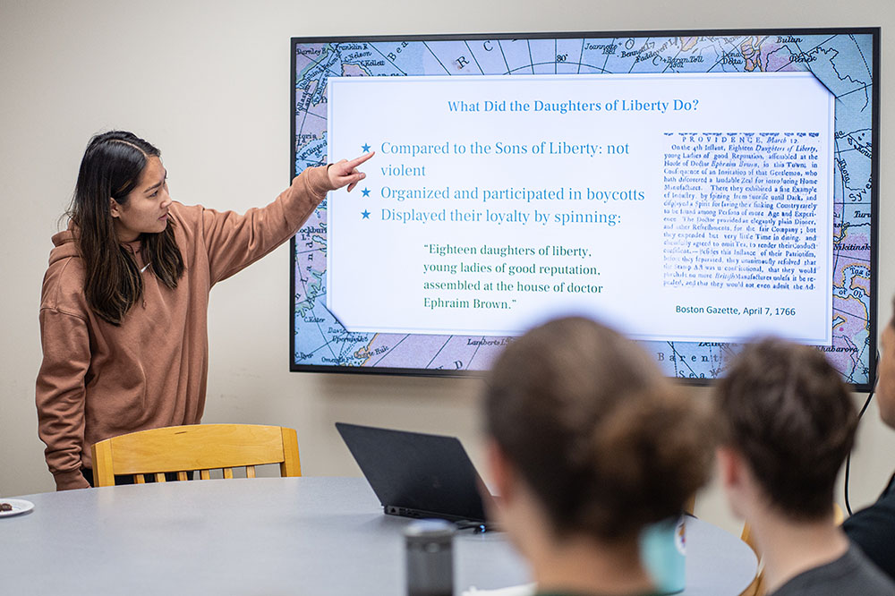 Student from History 201: American Revolutions presents final project to the class.