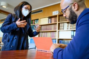 Emily Tran, a sixth year PhD student, gets Smith to sign her copy of “How the Word Is Passed." Photo by Althea Dotzour