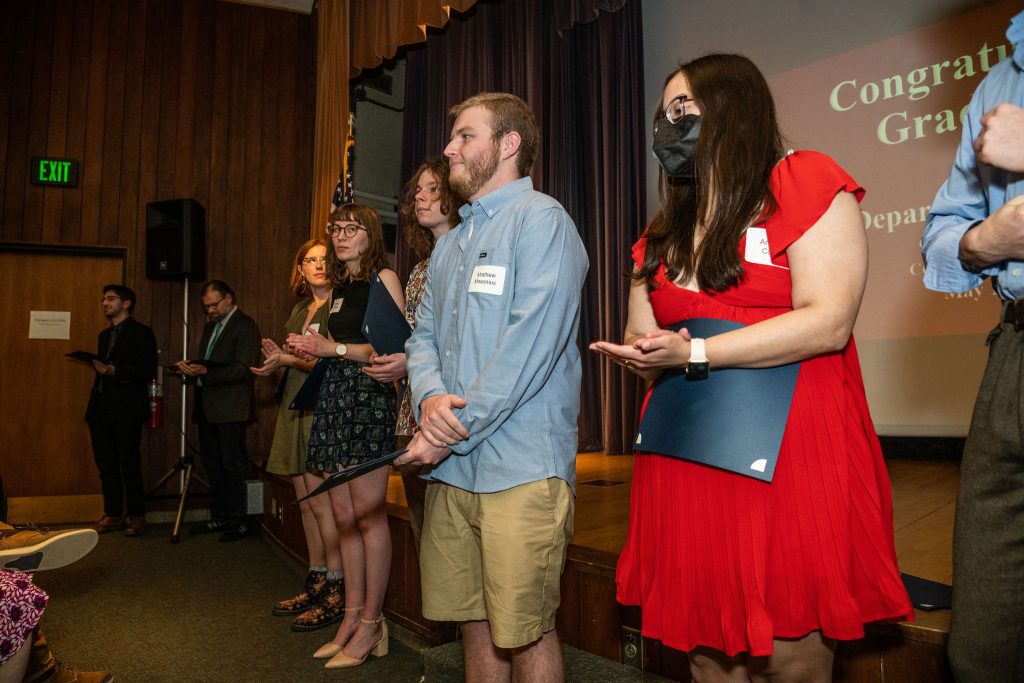 Award recipients line up in front of the stage.
