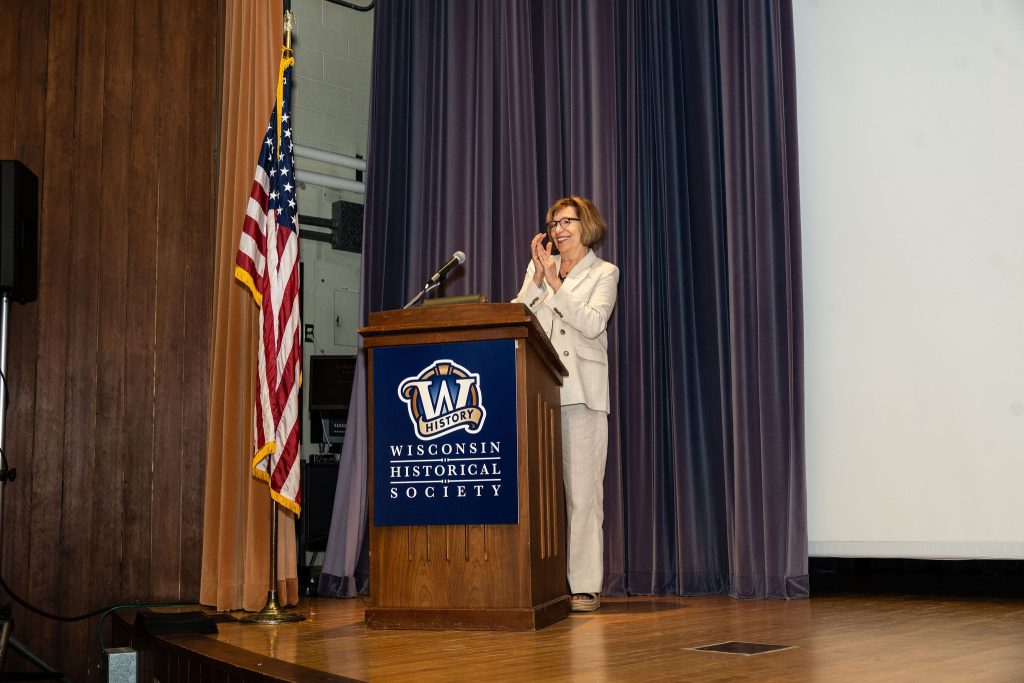 Professor Mary Lou Roberts applauds the graduates.