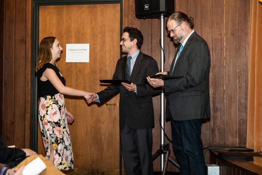 Professor Daniel Stolz and Undergraduate Advisor Scott Burkhardt congratulate graduates and hand them their commemorative certificates.