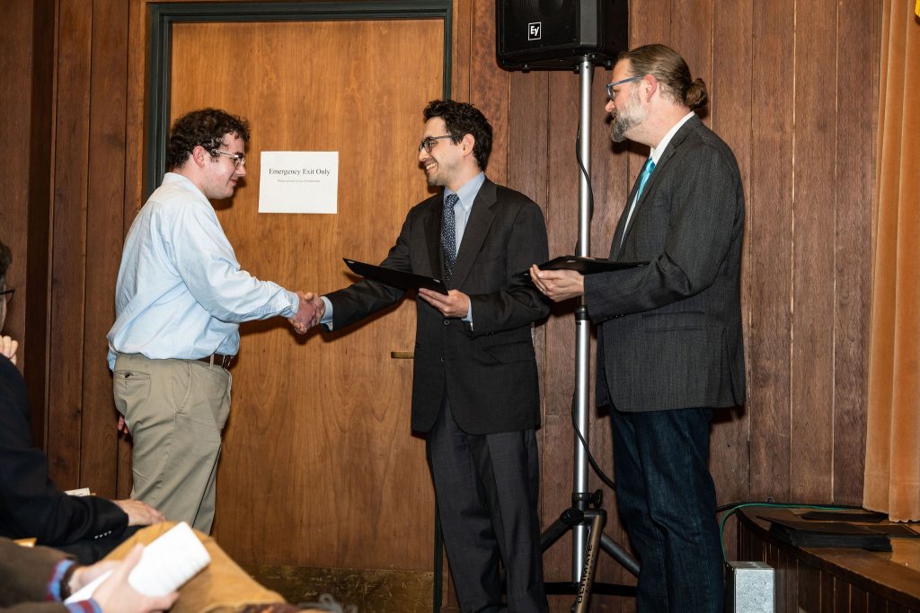 Professor Daniel Stolz and Undergraduate Advisor Scott Burkhardt congratulate graduates and hand them their commemorative certificates.