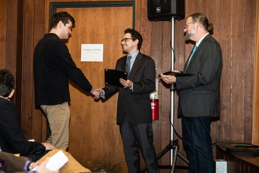 Professor Daniel Stolz and Undergraduate Advisor Scott Burkhardt congratulate graduates and hand them their commemorative certificates.