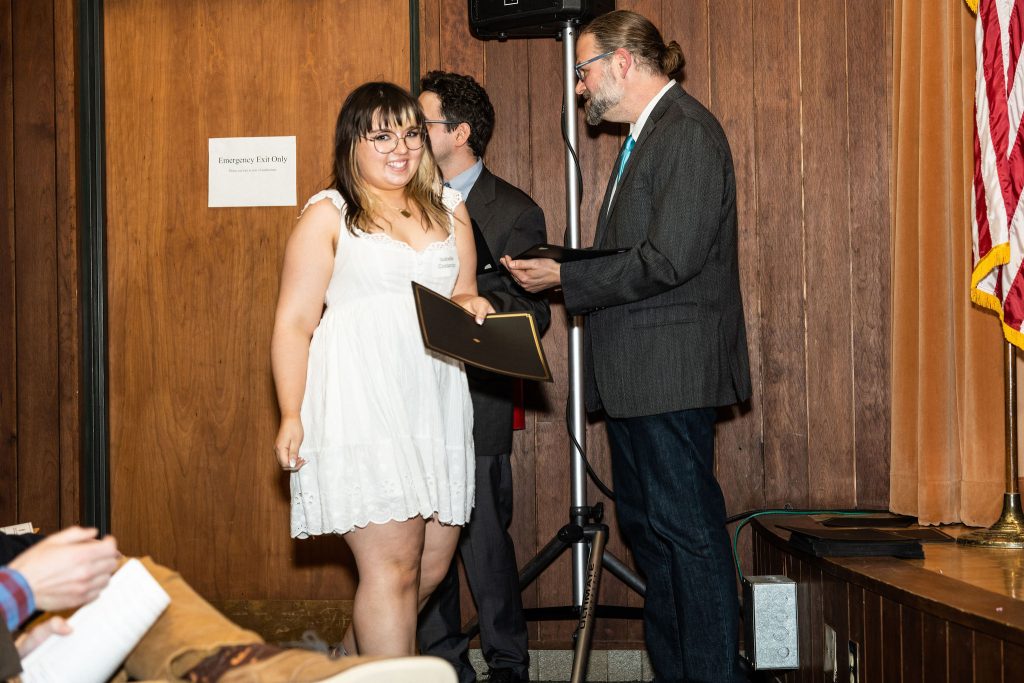 Professor Daniel Stolz and Undergraduate Advisor Scott Burkhardt congratulate graduates and hand them their commemorative certificates.