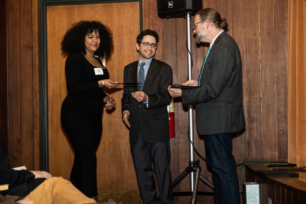 Professor Daniel Stolz and Undergraduate Advisor Scott Burkhardt congratulate graduates and hand them their commemorative certificates.