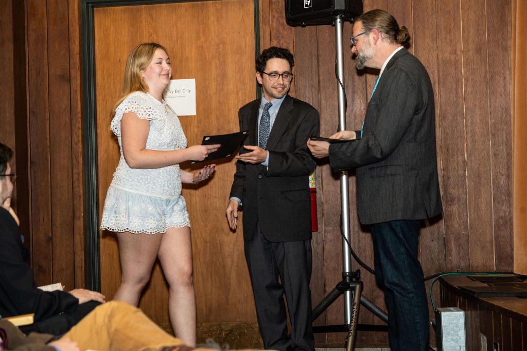Professor Daniel Stolz and Undergraduate Advisor Scott Burkhardt congratulate graduates and hand them their commemorative certificates.