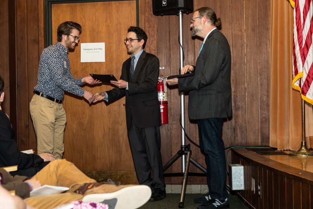 Professor Daniel Stolz and Undergraduate Advisor Scott Burkhardt congratulate graduates and hand them their commemorative certificates.