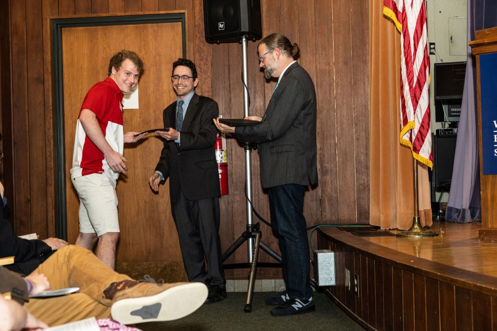 Professor Daniel Stolz and Undergraduate Advisor Scott Burkhardt congratulate graduates and hand them their commemorative certificates.