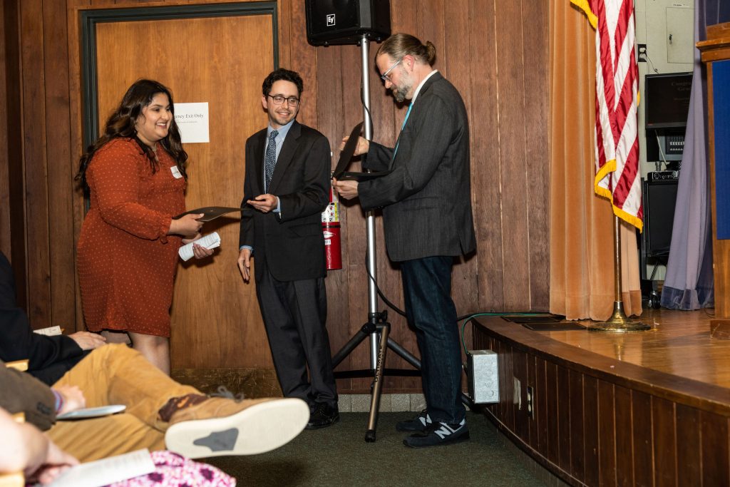 Professor Daniel Stolz and Undergraduate Advisor Scott Burkhardt congratulate graduates and hand them their commemorative certificates.