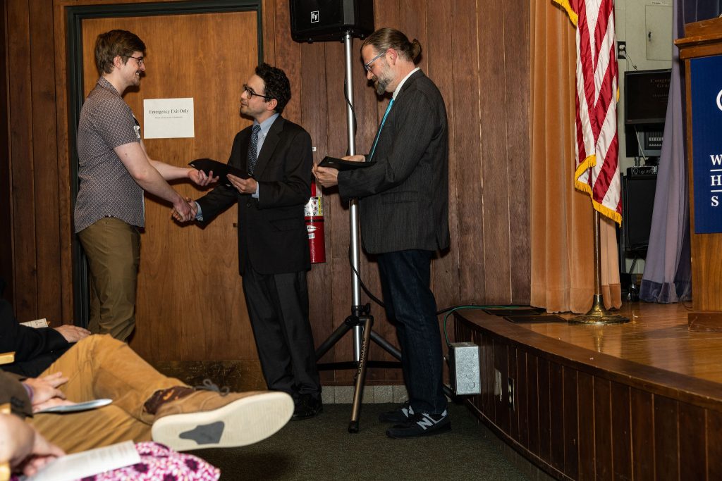 Professor Daniel Stolz and Undergraduate Advisor Scott Burkhardt congratulate graduates and hand them their commemorative certificates.