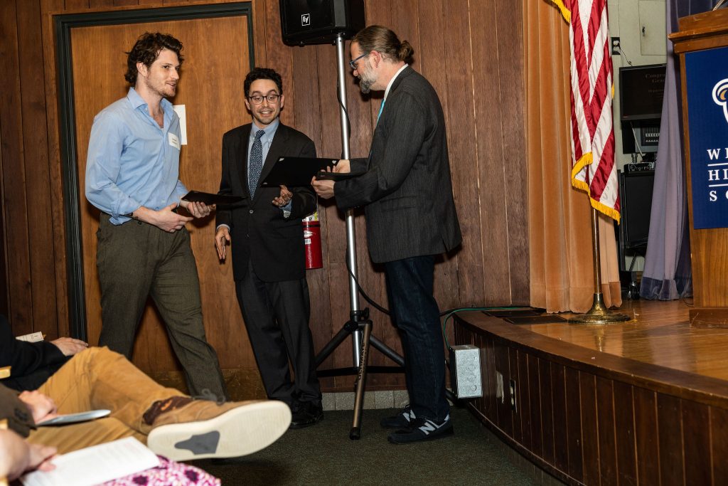 Professor Daniel Stolz and Undergraduate Advisor Scott Burkhardt congratulate graduates and hand them their commemorative certificates.