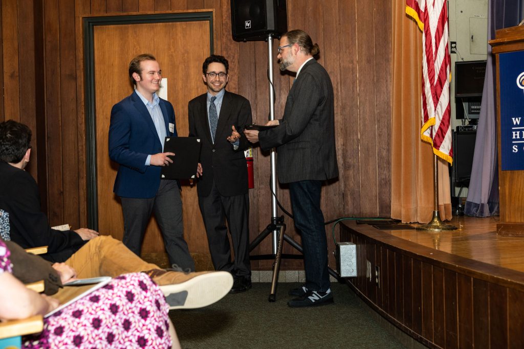 Professor Daniel Stolz and Undergraduate Advisor Scott Burkhardt congratulate graduates and hand them their commemorative certificates.