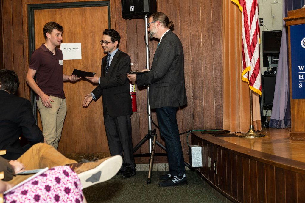 Professor Daniel Stolz and Undergraduate Advisor Scott Burkhardt congratulate graduates and hand them their commemorative certificates.