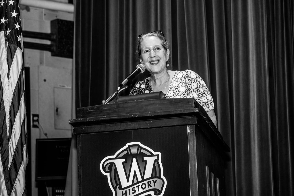 Professor Anne Hansen invites attendees to join the reception.