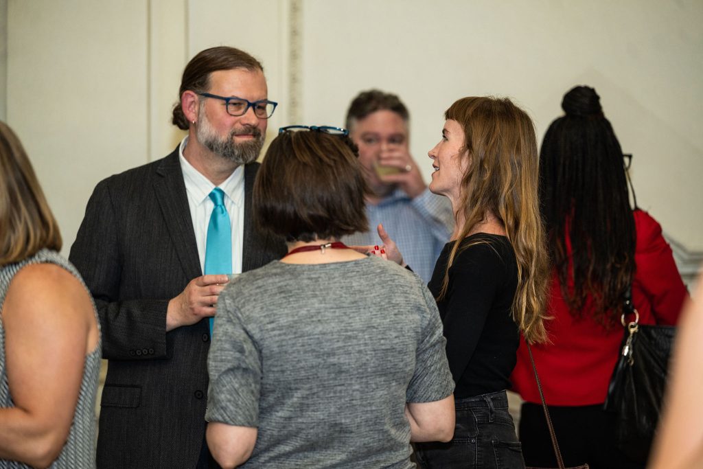 History staff and faculty celebrate with graduates at the reception.