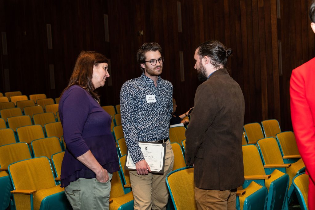 Professor Matt Villeneuve celebrates commencement with one of his senior thesis advisees.