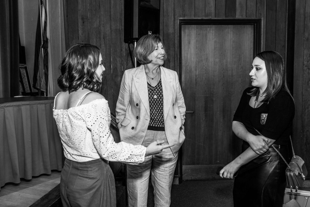Professor Mary Lou Roberts celebrates with graduates at the reception.