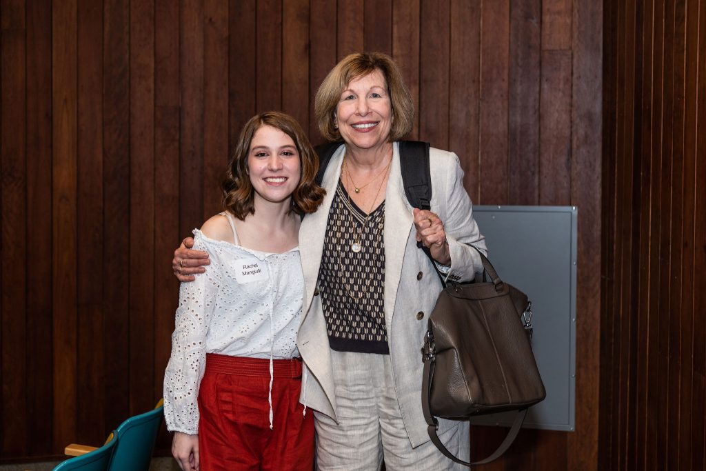 Professor Mary Lou Roberts celebrates with graduates at the reception.