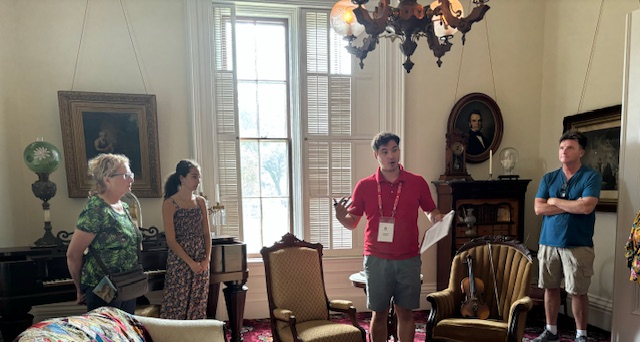 guests listening to a speaker in a period room