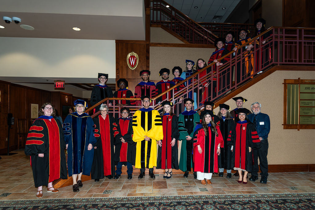 PhD graduates and faculty advisors at the Fluno Center, May 2026