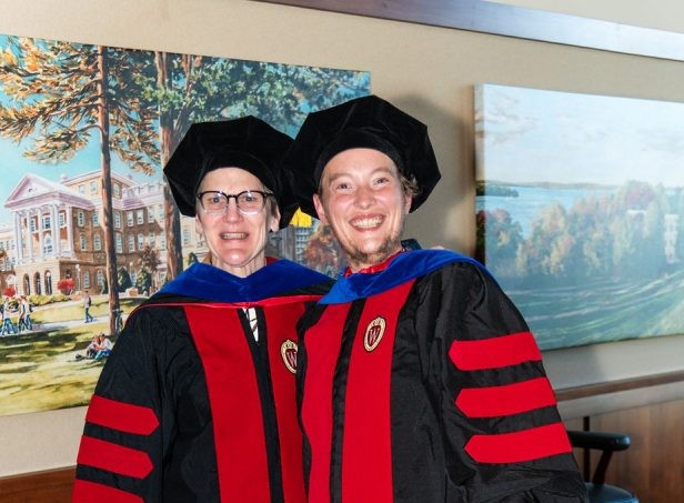 Portrait photo of Suzanna Schulert, PhD graduate, and Judy Houck, faculty advisor in their academic regalia