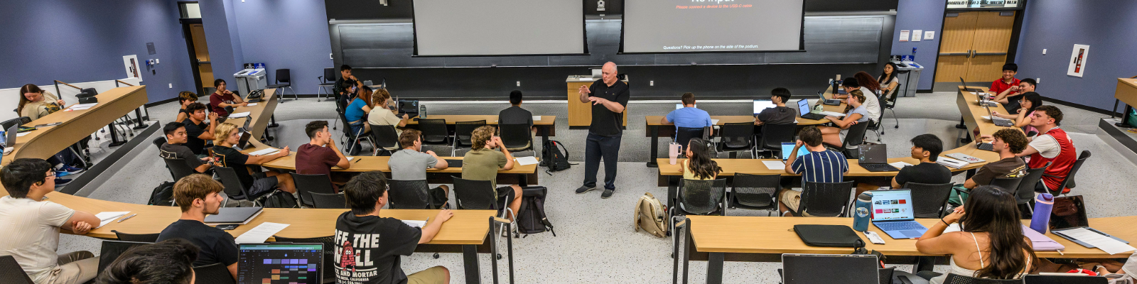 History Department Professor Joe Dennis speaks in front of a room with students on the first day of the fall semester 2026 in the newly opened Irving & Dorothy Levy Hall. (Photo Credit: Althea Dotzour / UW-Madison)